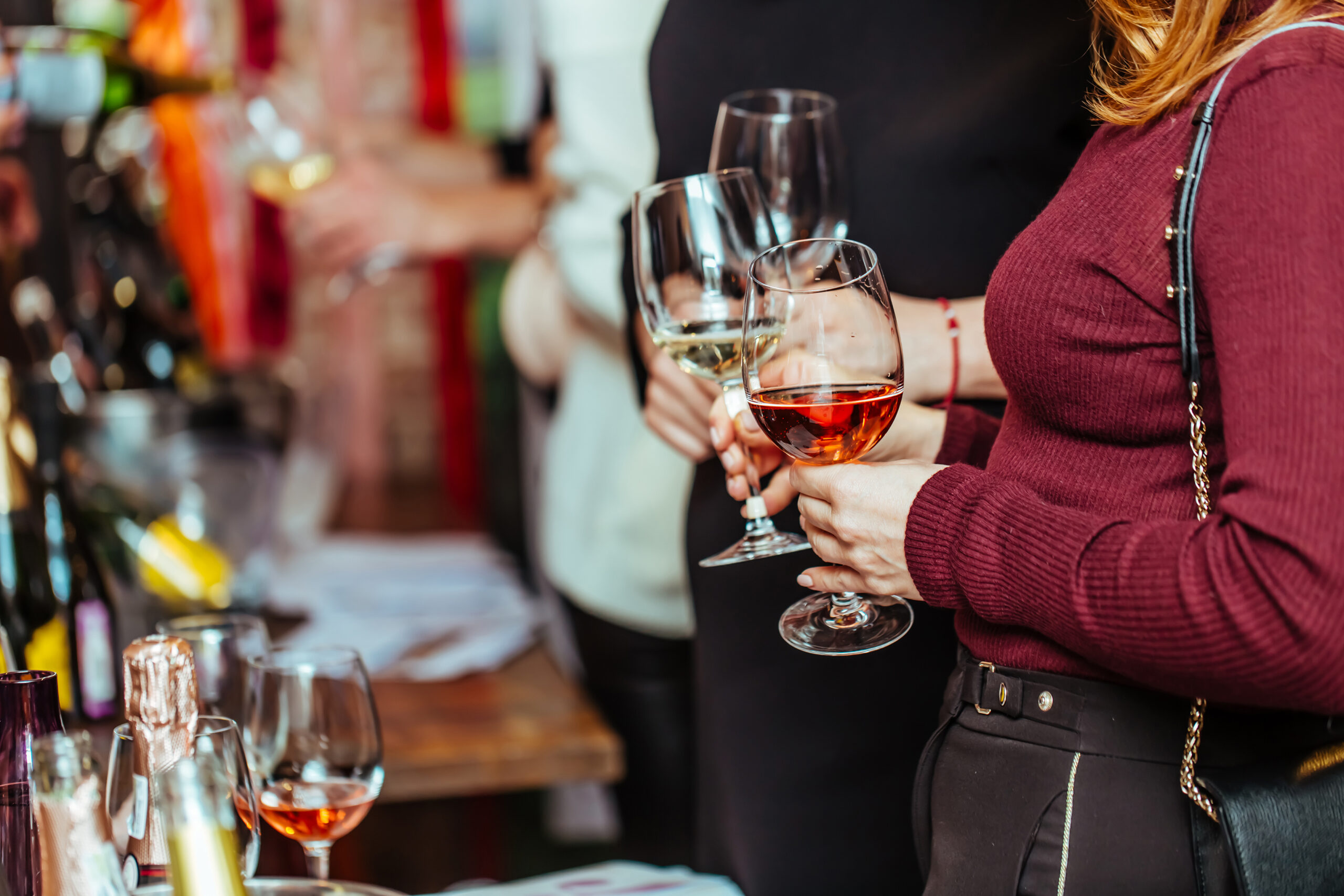 wine tasting: visitors stand near tables with tasting samples a Local Cellars Store Interior